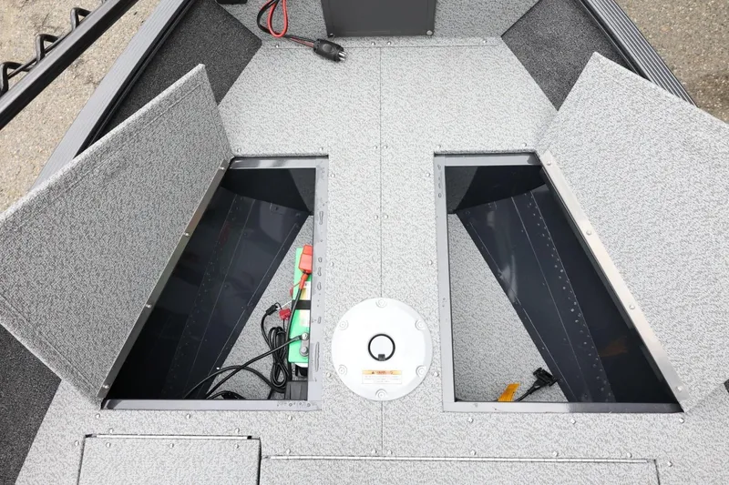 Slide: The Image of 2026 Lund 1650 Angler SS boat interior with open storage compartments and wiring. - 15
