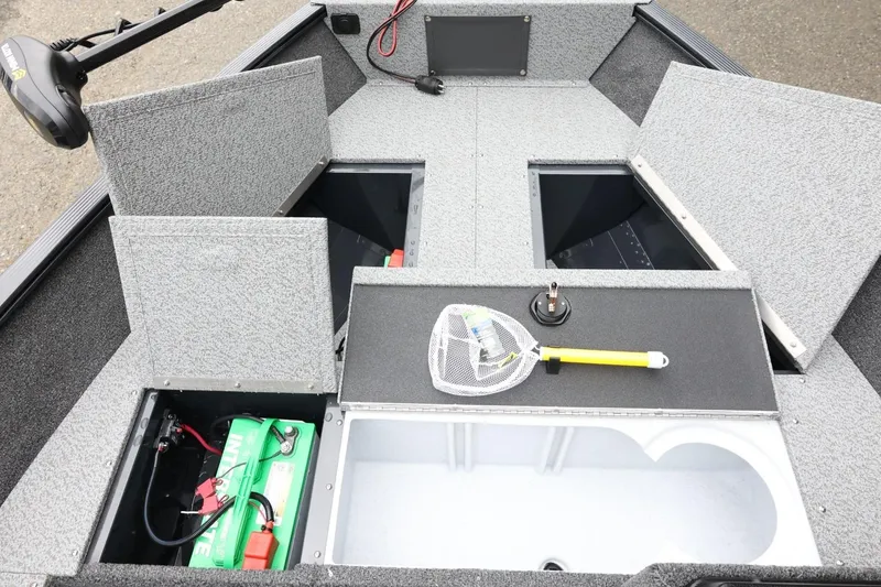 Slide: The Image of 2026 Lund 1650 Angler SS boat interior with storage compartments and fishing gear. - 16