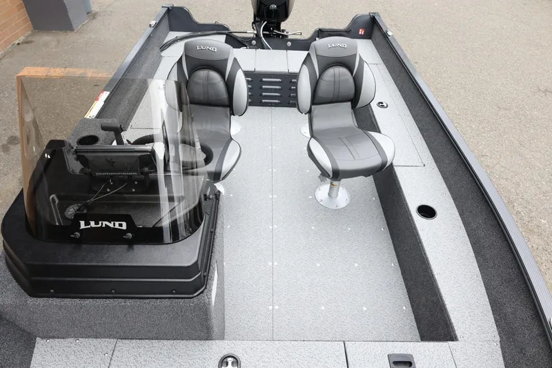 Slide: The Image of 2026 Lund 1650 Angler SS boat interior with two seats and steering console. - 17