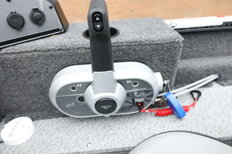 Slide: The Image of Throttle control panel of 2026 Lund 1650 Angler SS boat, featuring safety lanyard. - 20