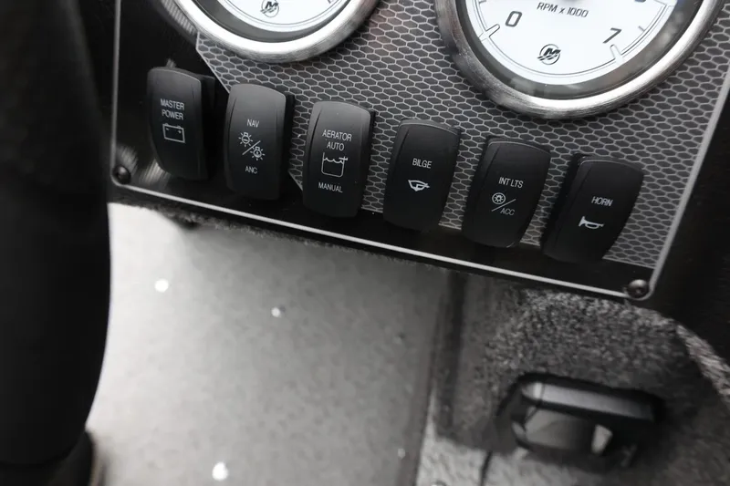 Slide: The Image of Dashboard controls of 2026 Lund 1650 Angler SS boat with switches and gauges. - 21