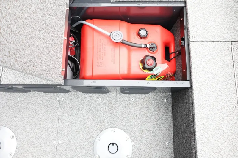 Slide: The Image of 2026 Lund 1650 Angler SS boat fuel compartment with red fuel tank. - 24