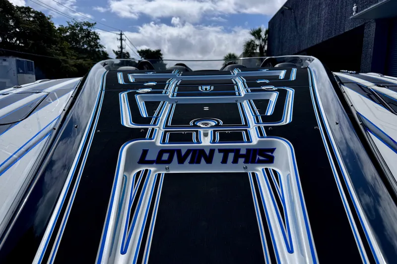 Slide: The Image of 2025 MTI 440 boat with sleek design and "Lovin This" text on deck. - 10