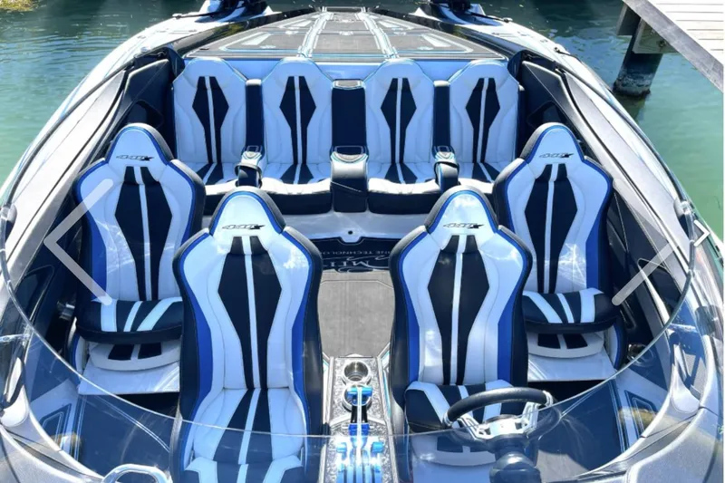 Slide: The Image of 2025 MTI 440 boat interior with sleek, modern seating design on water. - 11