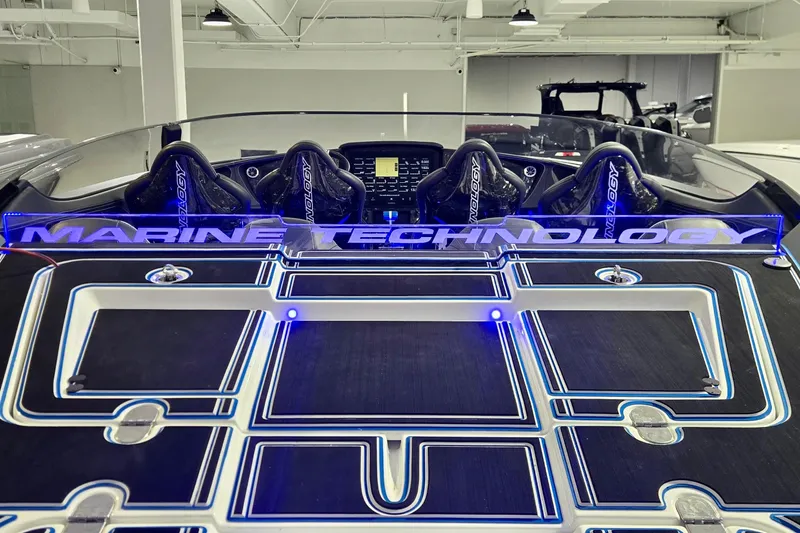 Slide: The Image of 2025 MTI 440 boat interior with illuminated "Marine Technology" branding and advanced seating. - 15