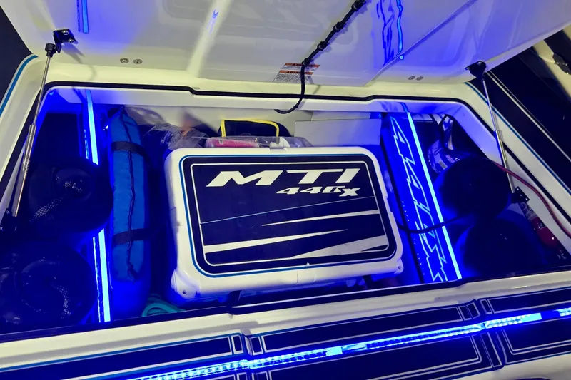 Slide: The Image of Open storage compartment of 2025 MTI 440 model, featuring blue LED lighting and equipment. - 16