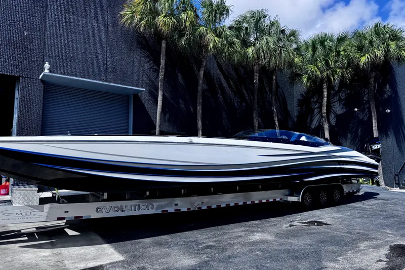 Slide: The Image of 2025 MTI 440 powerboat on trailer, sleek design, parked near palm trees. - 3