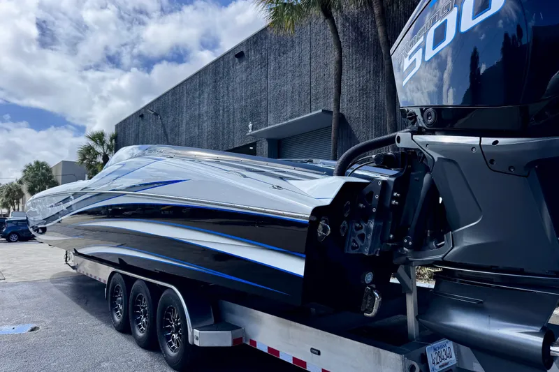Slide: The Image of 2025 MTI 440 powerboat on trailer, featuring sleek design and powerful engine. - 8