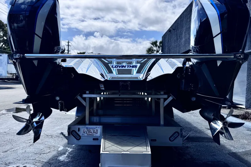 Slide: The Image of 2025 MTI 440 boat with dual engines on a trailer, under a partly cloudy sky. - 9