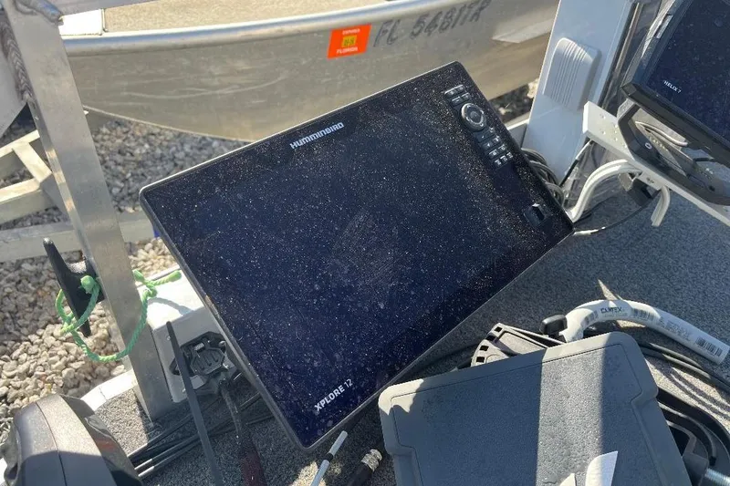 Slide: The Image of Humminbird Xplore 12 fish finder on 2024 CustomBilt Pondtoon 1672 boat deck. - 10