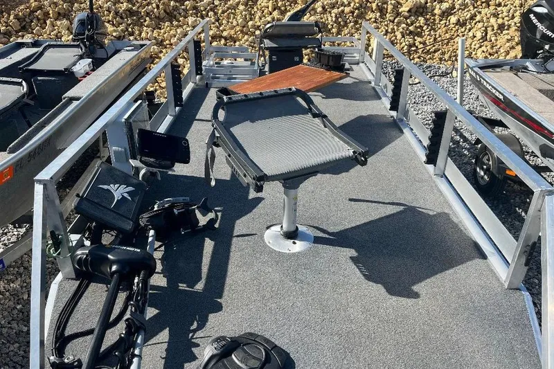 Slide: The Image of 2024 CustomBilt Pondtoon 1672 boat deck with fishing equipment and seating. - 11