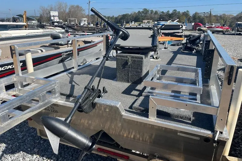 Slide: The Image of 2024 CustomBilt Pondtoon 1672 boat with aluminum frame and trolling motor in a marina. - 5