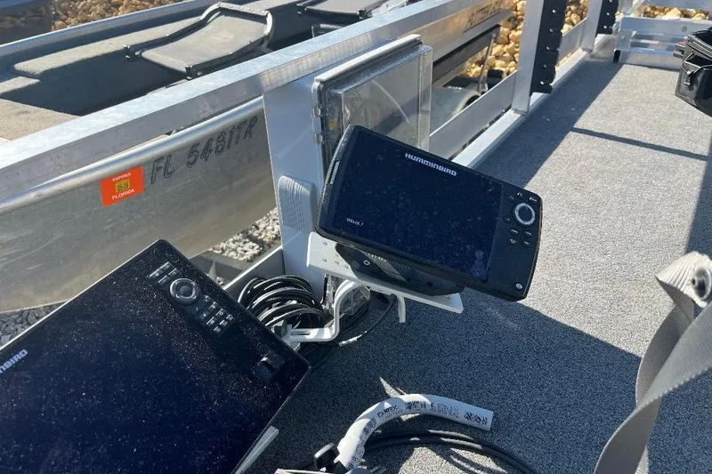 Slide: The Image of 2024 CustomBilt Pondtoon 1672 with advanced navigation equipment and Florida registration. - 9