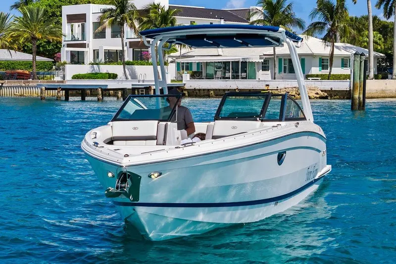 Slide: The Image of 2022 Cobalt R8 Outboard boat cruising in clear blue water near luxury waterfront homes. - 14