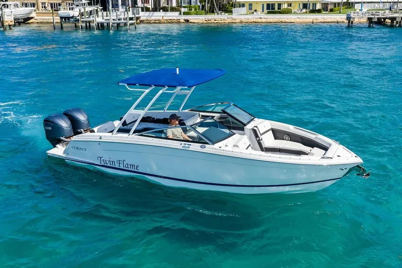 Slide: The Image of 2022 Cobalt R8 Outboard boat "Twin Flame" on clear blue water. - 16