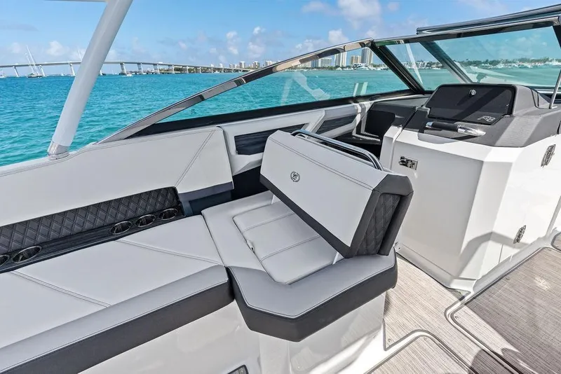 Slide: The Image of 2022 Cobalt R8 Outboard boat interior with luxurious seating and scenic ocean view. - 23