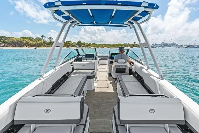Slide: The Image of 2022 Cobalt R8 Outboard boat cruising on clear blue water near a tropical shoreline. - 33