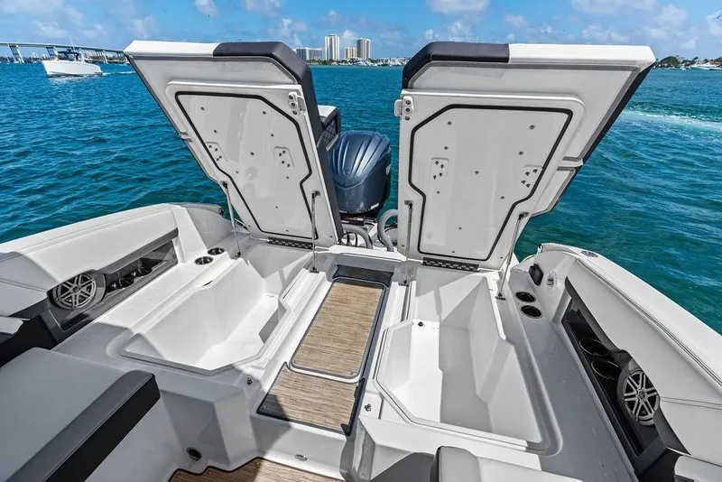 Slide: The Image of 2022 Cobalt R8 Outboard boat with open storage compartments on a sunny day. - 39