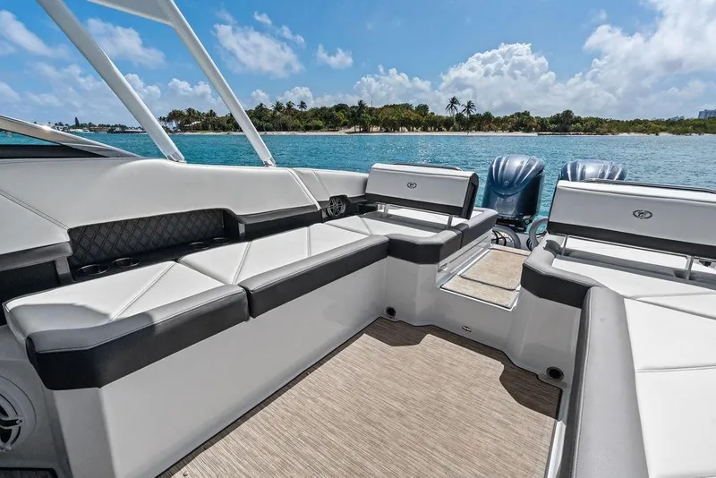 Slide: The Image of 2022 Cobalt R8 Outboard boat interior with luxurious seating, ocean view, and clear blue sky. - 7
