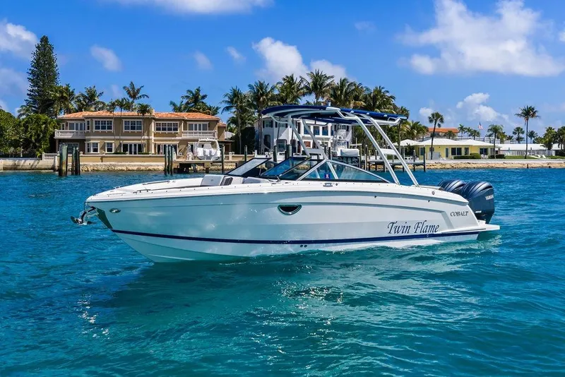 Slide: The Image of 2022 Cobalt R8 Outboard boat on clear blue water near luxury waterfront homes. - 9