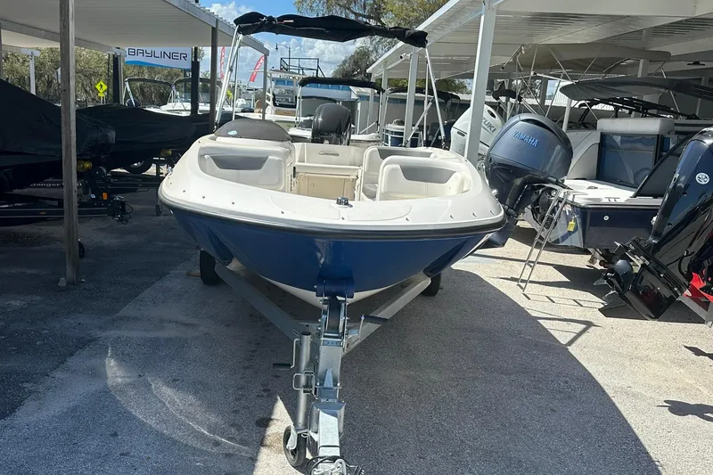 The Image of 2025 Bayliner Element E18 boat on trailer in outdoor showroom. - 0