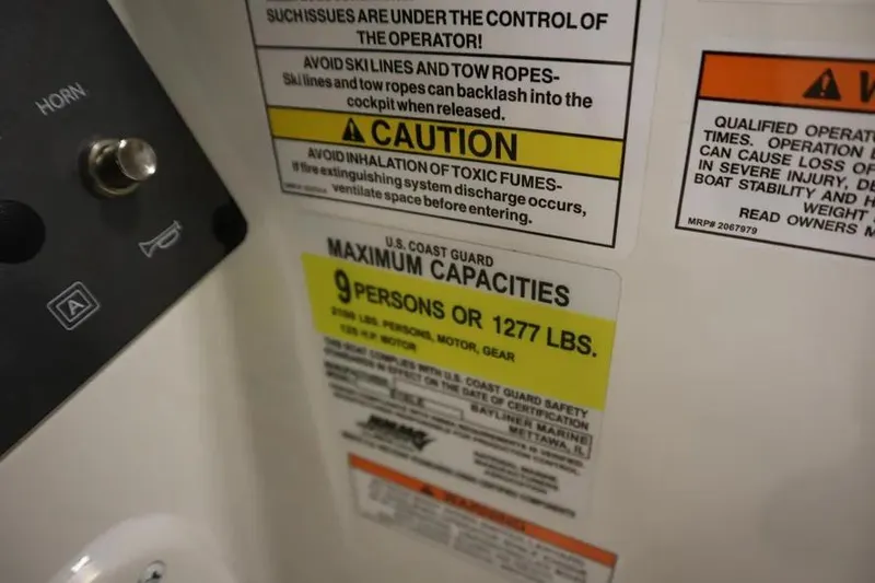 Slide: The Image of 2025 Bayliner Element E18 capacity warning label, maximum 9 persons or 1277 lbs. - 10