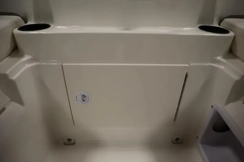 Slide: The Image of 2025 Bayliner Element E18 boat interior with storage compartment and cup holders. - 14