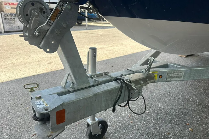 Slide: The Image of Trailer hitch of 2025 Bayliner Element E18 boat on pavement. - 20