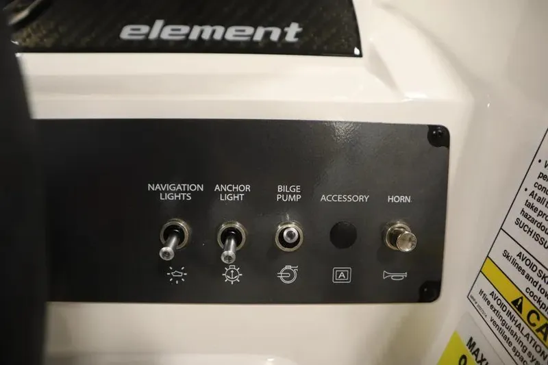 Slide: The Image of Control panel of 2025 Bayliner Element E18 boat with switches for lights and horn. - 9