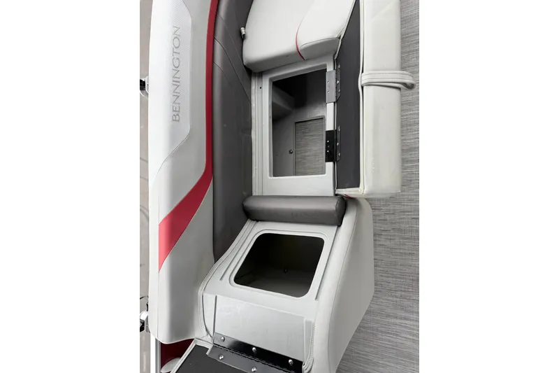 Slide: The Image of 2023 Bennington 22 SX Quad Bench interior with open storage compartments. - 11