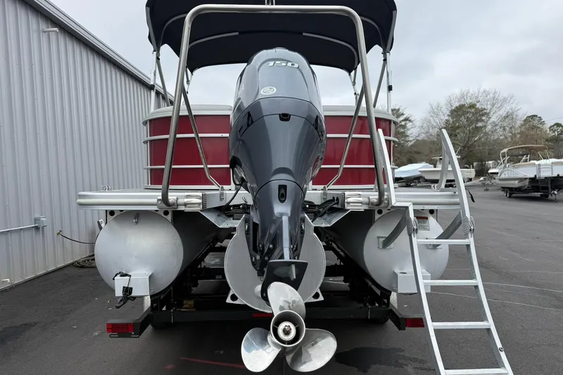 Slide: The Image of 2023 Bennington 22 SX Quad Bench pontoon boat with powerful outboard motor. - 13
