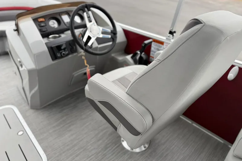 Slide: The Image of 2023 Bennington 22 SX Quad Bench boat interior with steering wheel and captain's chair. - 3