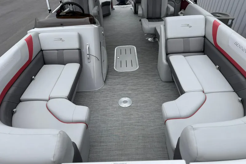 Slide: The Image of 2023 Bennington 22 SX Quad Bench interior with gray and red seating, spacious layout. - 6