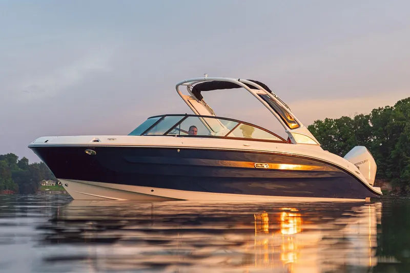 The Image of 2026 Sea Ray SDX 250 Outboard boat, black and white, docked outside a warehouse. - 0