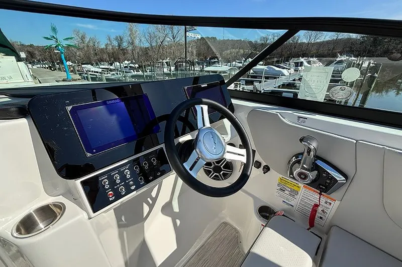 Slide: The Image of 2026 Sea Ray SDX 250 Outboard helm with modern controls and dual displays. - 17