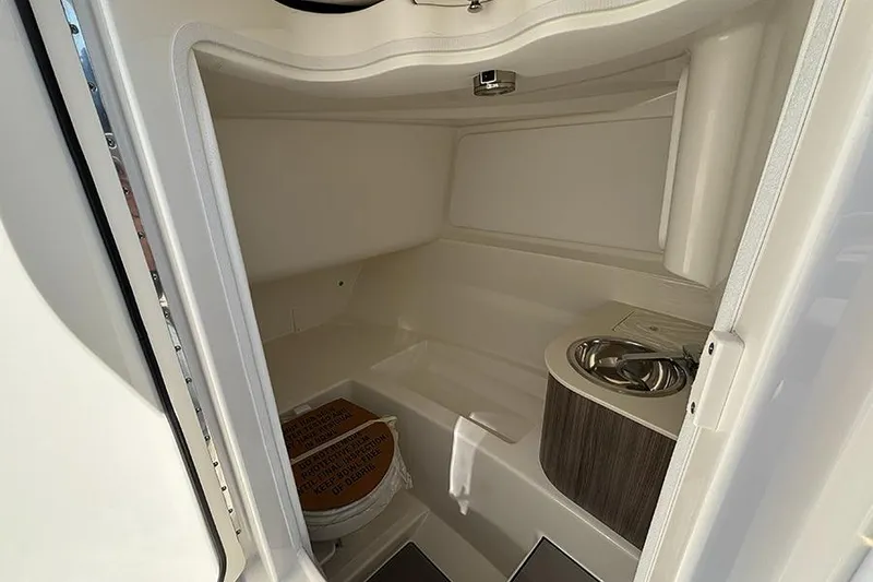 Slide: The Image of 2026 Sea Ray SDX 250 Outboard interior cabin with sink and toilet. - 18