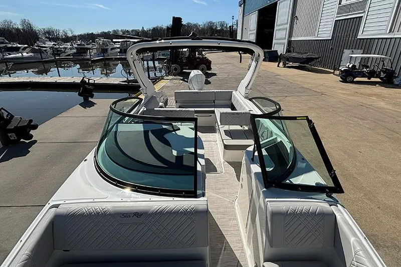 Slide: The Image of 2026 Sea Ray SDX 250 Outboard boat docked, showcasing spacious seating and sleek design. - 21