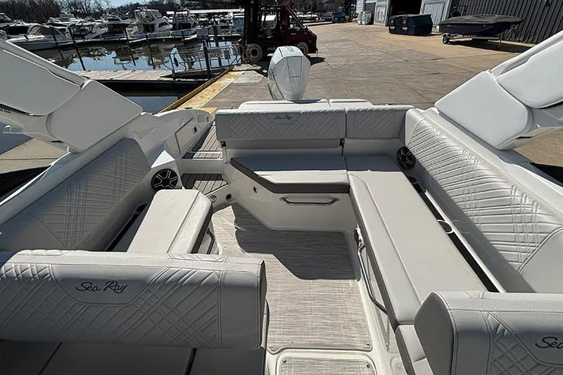 Slide: The Image of 2026 Sea Ray SDX 250 Outboard boat interior with luxurious seating at marina. - 27