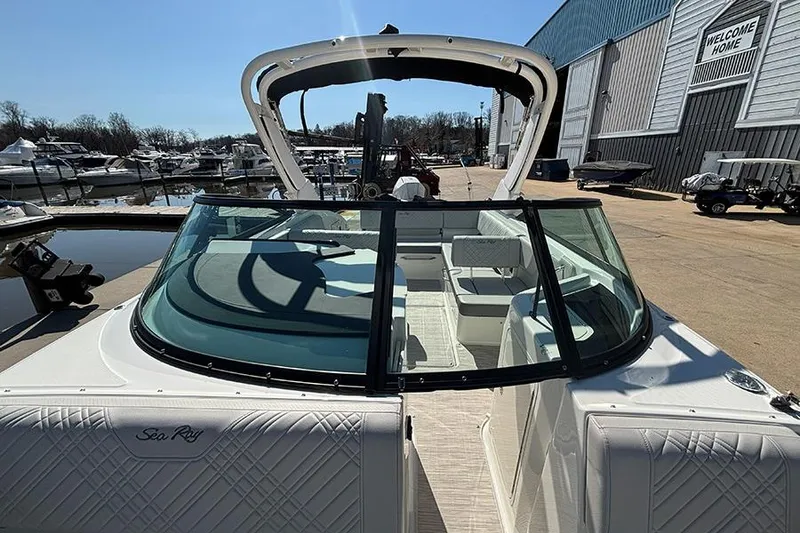 Slide: The Image of 2026 Sea Ray SDX 250 Outboard boat docked at a marina, showcasing sleek design. - 28