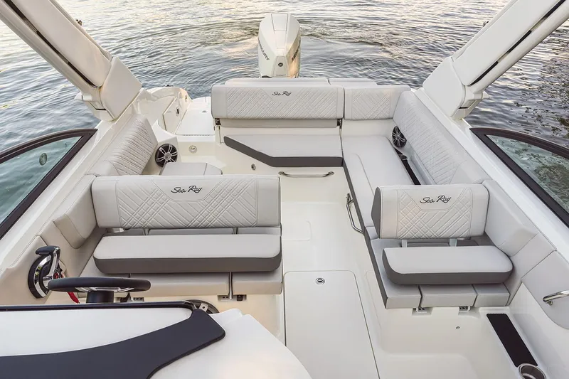 Slide: The Image of 2026 Sea Ray SDX 250 Outboard boat interior with seating and helm, docked at marina. - 5