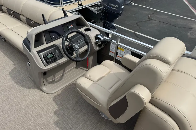 Slide: The Image of 2024 Sun Tracker Party Barge 24 DLX interior with steering console and seating. - 6