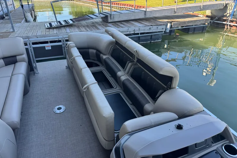 Slide: The Image of 2024 Sun Tracker Party Barge 24 DLX pontoon boat with spacious seating at a dock. - 8