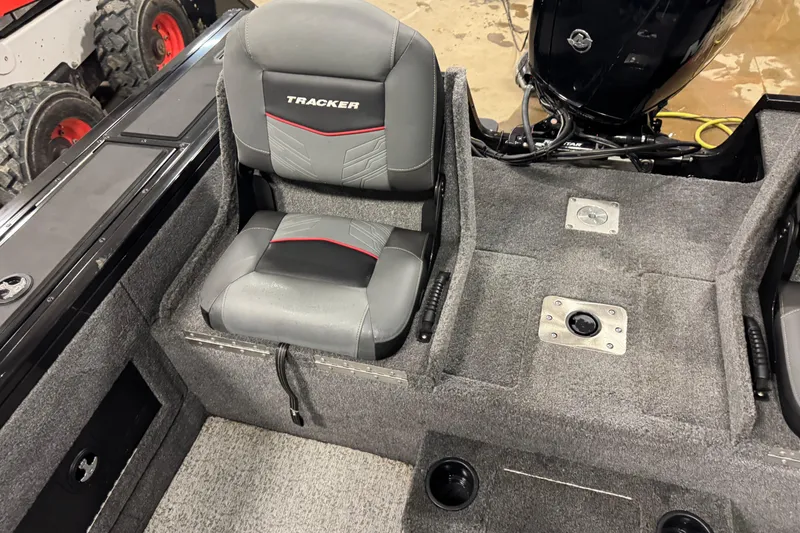 Slide: The Image of 2024 Tracker Targa V-18 Combo boat interior with gray seating and carpeted flooring. - 12