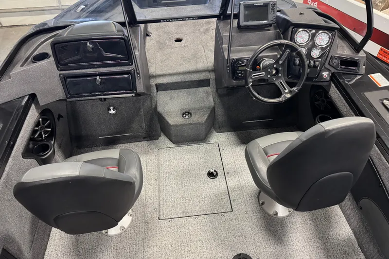 Slide: The Image of 2024 Tracker Targa V-18 Combo boat interior with dual seats and control panel. - 16