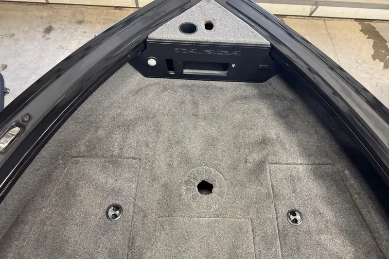 Slide: The Image of 2024 Tracker Targa V-18 Combo boat interior with carpeted deck and storage compartments. - 17