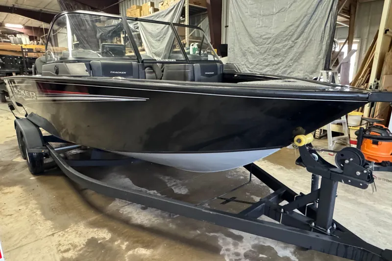 Slide: The Image of 2024 Tracker Targa V-18 Combo boat on trailer in a storage facility. - 2