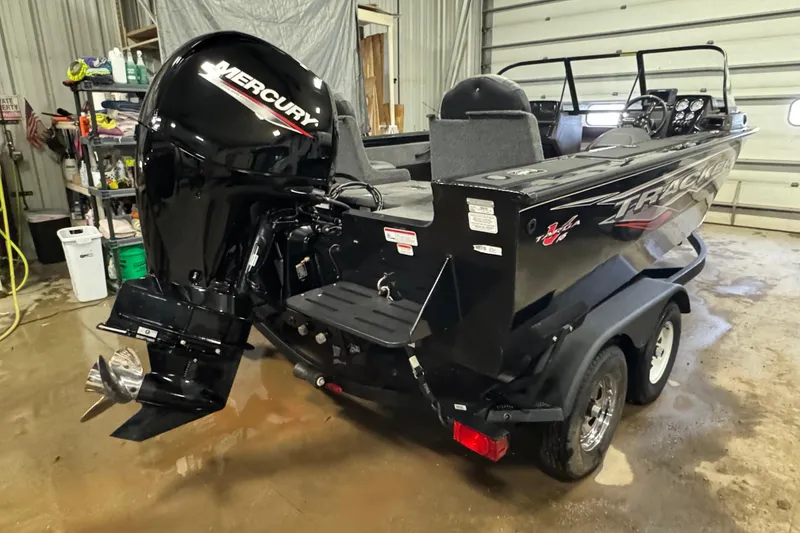 Slide: The Image of 2024 Tracker Targa V-18 Combo boat with Mercury outboard motor in a garage. - 3