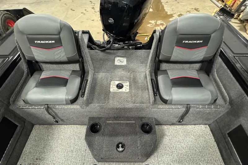 Slide: The Image of 2024 Tracker Targa V-18 Combo boat interior with two gray seats and cup holders. - 6