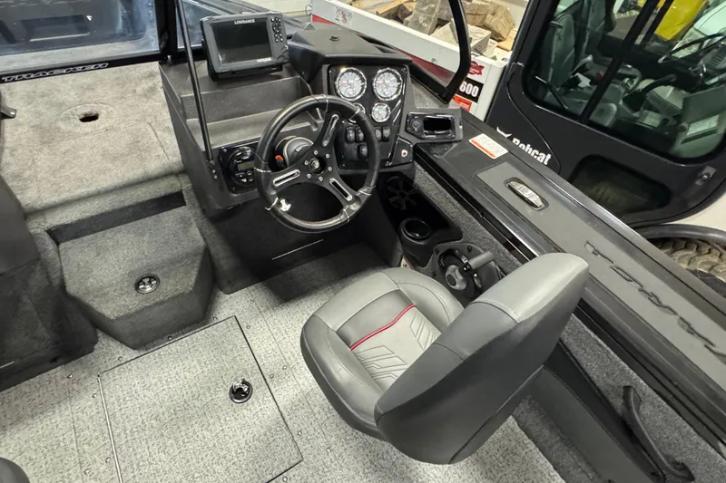Slide: The Image of 2024 Tracker Targa V-18 Combo boat interior with steering wheel and control panel. - 7