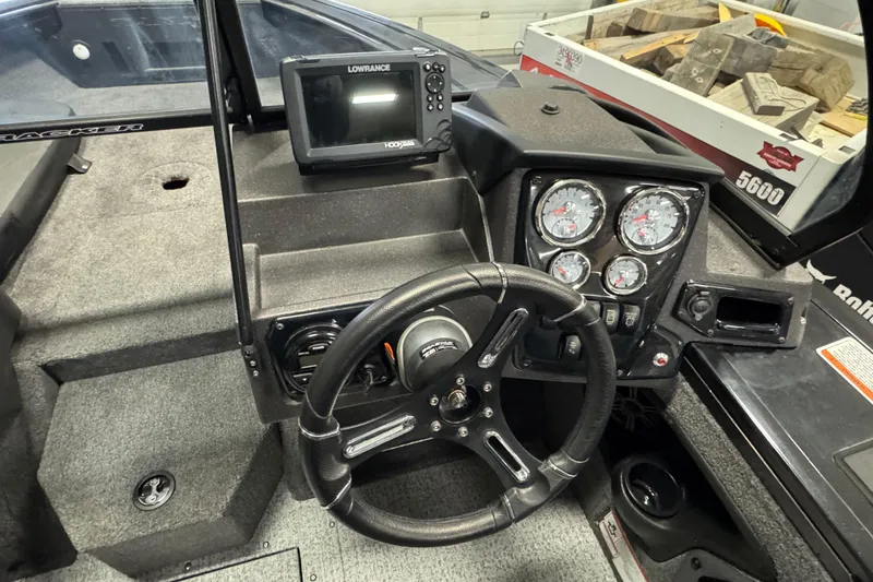 Slide: The Image of 2024 Tracker Targa V-18 Combo dashboard with steering wheel and gauges. - 8